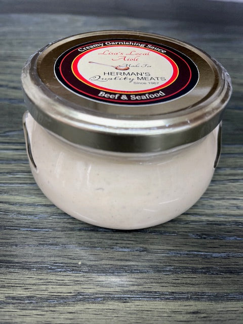 small glass jar of Lisa's Local Aioli on table